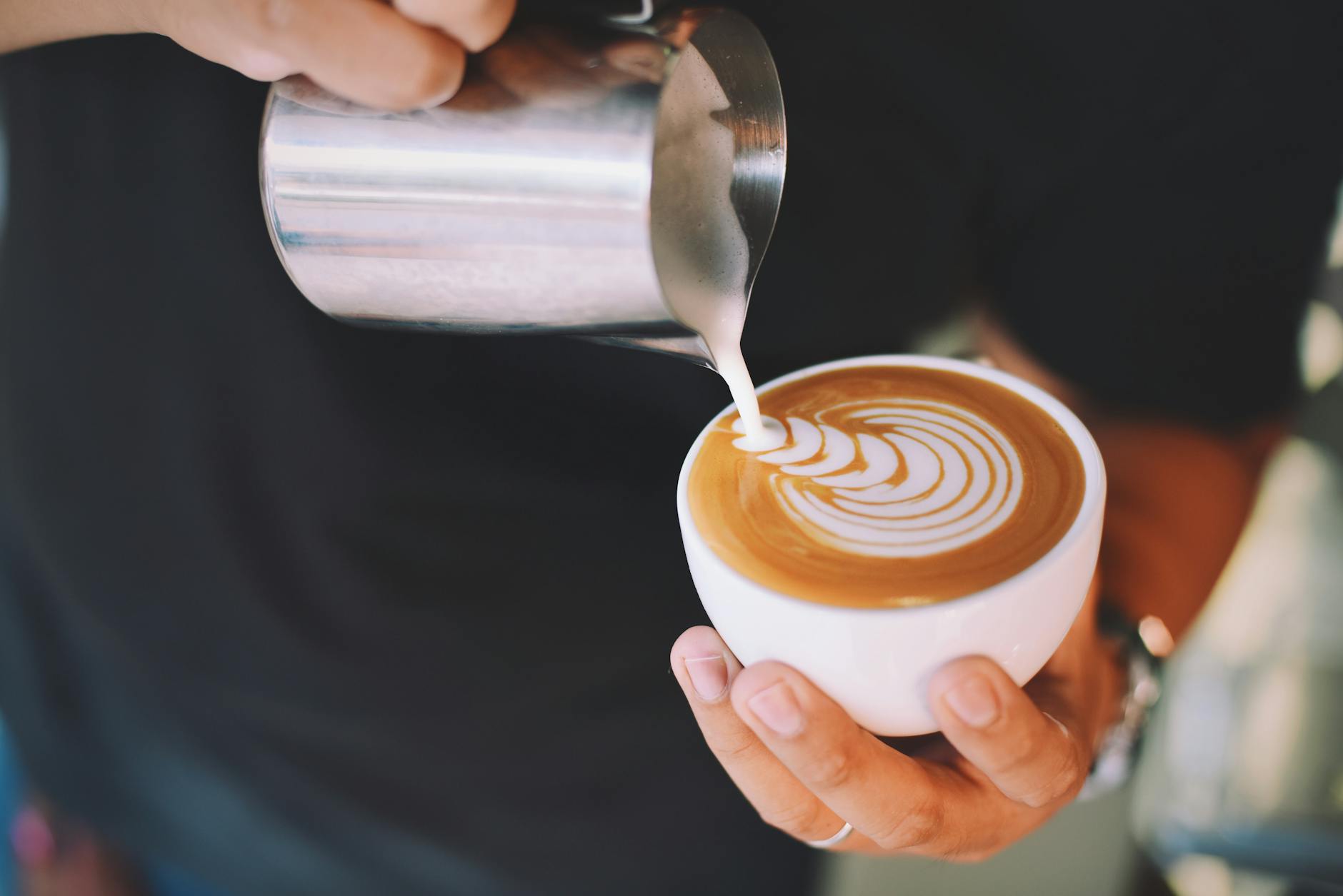 Oat milk latte art created by a barista