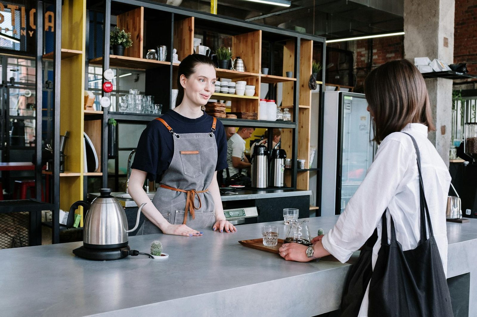 Customer ordering at a coffee shop counter