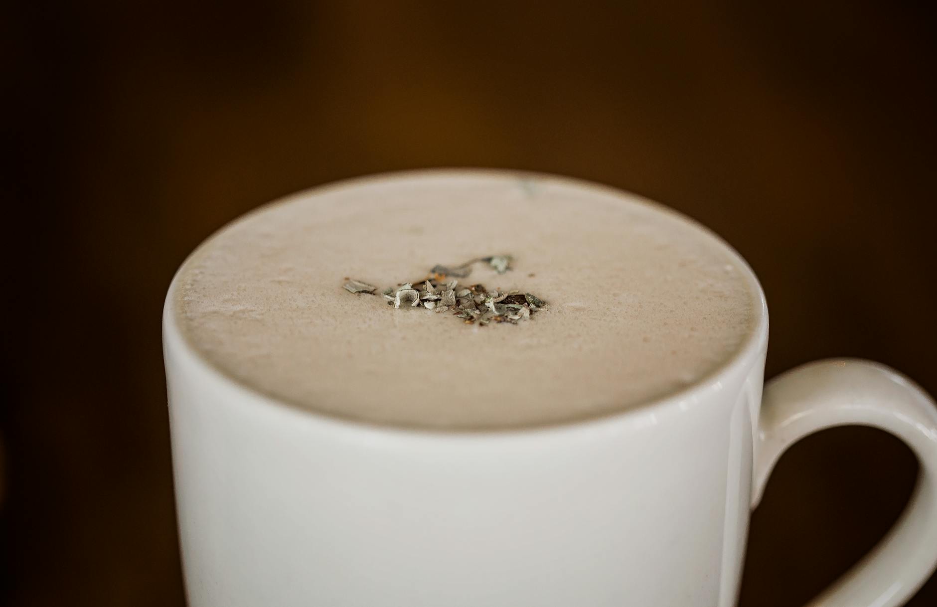 A warm chai latte in a ceramic mug on a cozy surface