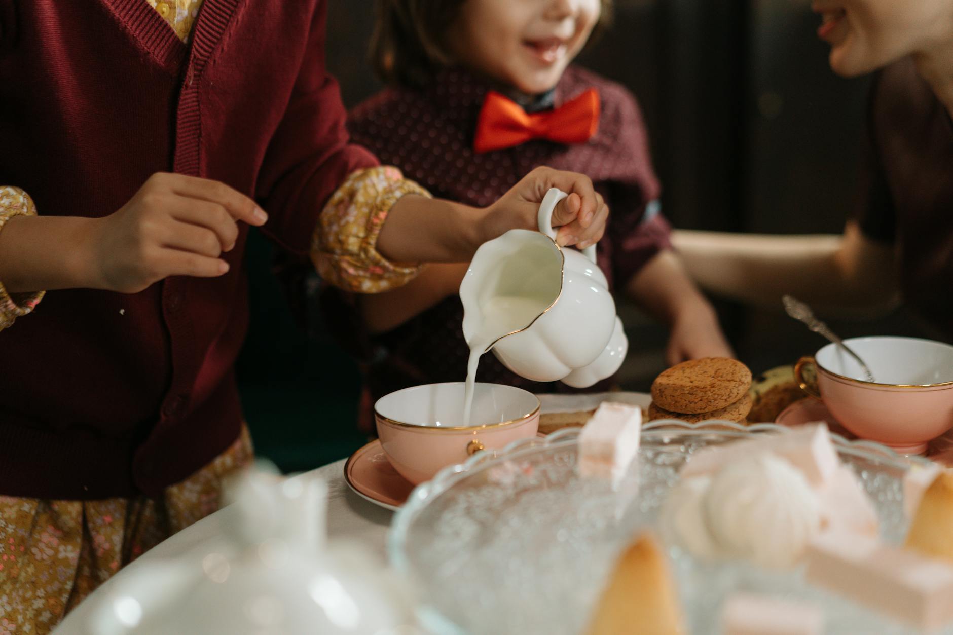 Steamed milk being poured into a cup of spiced chai