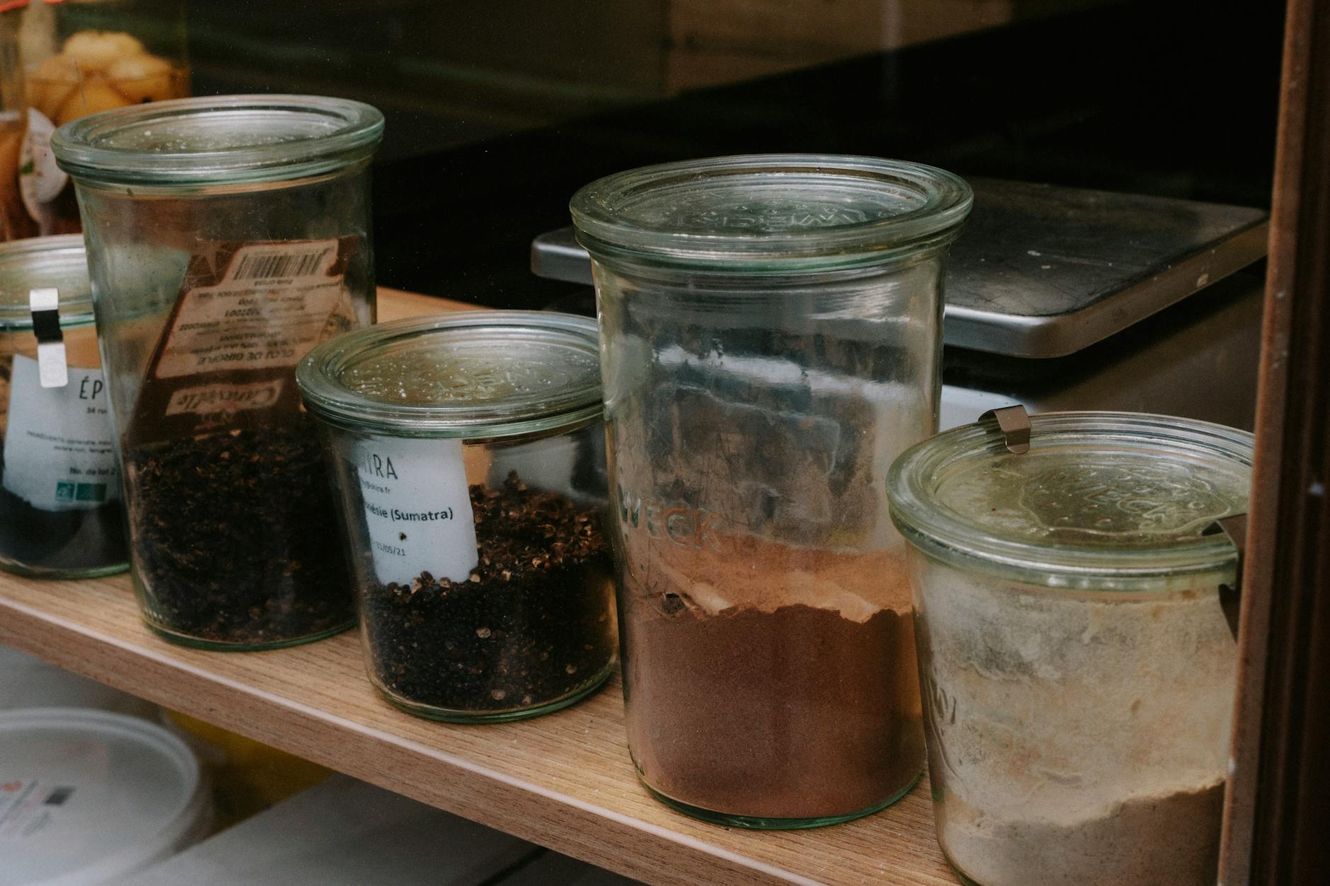 Organized spice jars on a kitchen shelf